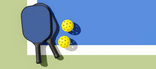 Pickleball equipment including paddles and balls resting on a court, illustrating the transition from tennis gear.