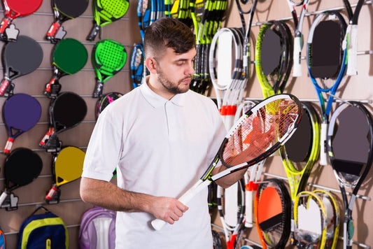 A person selecting racquet sports equipment in a Winnipeg store